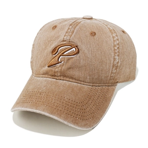 Detailed close-up of khaki washed cotton baseball cap with embroidered P letter logo