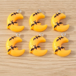 Detailed view of orange moon and black bat pendants for Halloween jewelry making