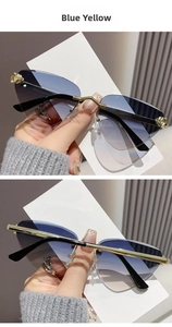 Detailed view of frameless blue and yellow gradient sunglasses with gold leopard metal hinges