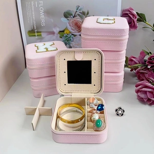 Pink square jewelry travel box with embroidered letter, internal mirror and ring slots