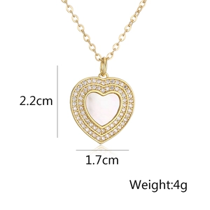 Detailed view of gold heart pendant with zircon and white shell including dimensions