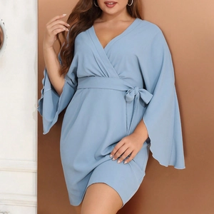 Detail of light blue plus size dress featuring V-neckline and elegant lantern sleeves