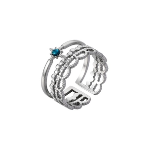 Detail of silver dual-layer open ring featuring a blue gemstone and hollow lace pattern