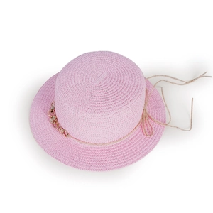 Close-up of pink straw hat showing detailed woven texture and metallic chain decoration