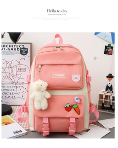 Detailed close-up of pink and white canvas school backpack with cute plush bear charms