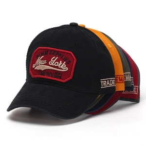 Detail of vintage New York letter embroidery on washed cotton baseball caps in six colors