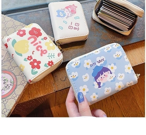 Detail of multi-slot accordion card holder with cute floral and cartoon illustrations