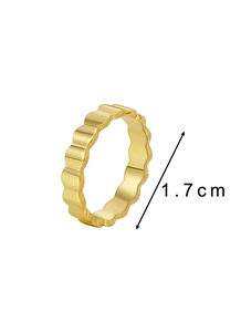 Detail view of a gold wavy band ring with polished finish and 1.7cm diameter dimension