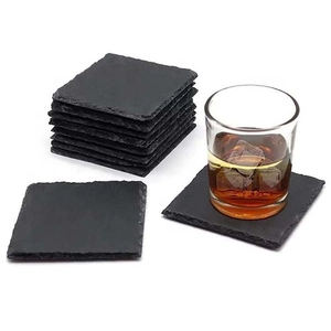 Natural square black slate coasters for drinks with handcrafted edges and whiskey glass