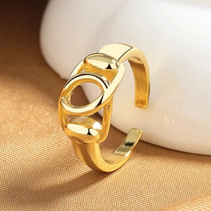 Macro shot of an adjustable gold open ring on textured champagne fabric background