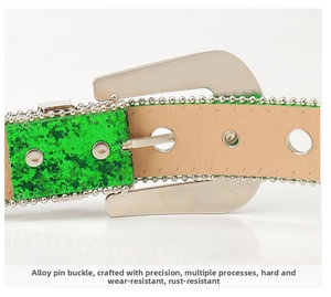 Detail of green sequin belt with silver ball trim and thick alloy buckle on white background