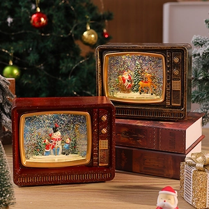 Detail of vintage TV-shaped Christmas music boxes with swirling snow and festive lights