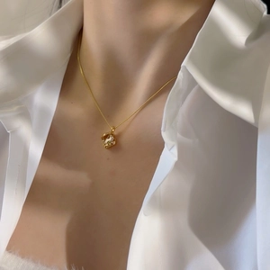 Elegant gold necklace with irregular square zircon pendant shown on model neck