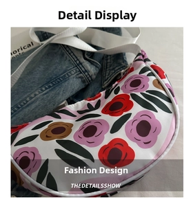 Detail view of crescent floral bag featuring white zipper edges and durable fabric strap