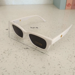 Detail view of white square frame kids sunglasses with UV400 size and weight dimensions