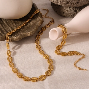 Luxury 18K gold plated stainless steel cowrie shell necklace and bracelet set on stone