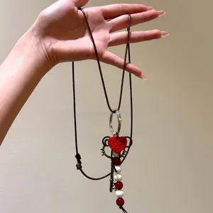 Hello Kitty style key pendant necklace with red heart and beads on brown cord