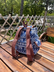Detail of ethnic canvas backpack with blue elephant pattern and adjustable webbed straps