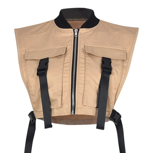 Detail of khaki utility vest showing multi-pocket design and adjustable buckle straps