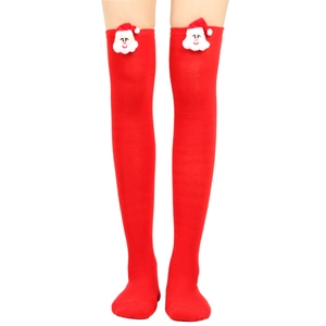 Detail of red Christmas over-knee socks with cute 3D Santa Claus plush ornaments