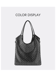 Detailed view of black tote bag with silver studs and premium leather texture