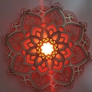 Detailed layered wood mandala wall art with warm LED lighting and laser-cut patterns
