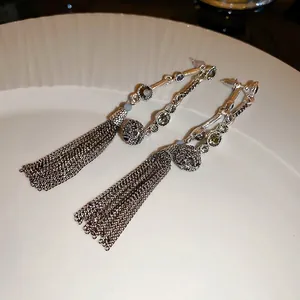 French vintage silver tassel earrings with green gemstones and textured metal spheres