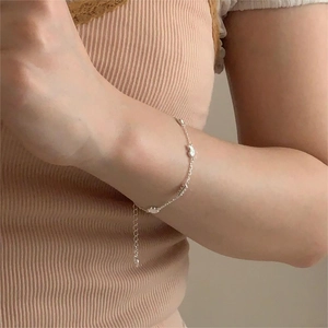 Detail of silver cloud bracelet worn on wrist with adjustable chain extension
