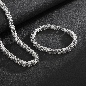 Byzantine style stainless steel necklace and bracelet set in silver on black background