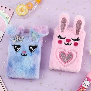 Detail of plush rabbit mini notebooks with soft fur texture and cute embroidery