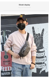 Outdoor model wearing dark grey waterproof waist bag with adjustable shoulder strap and zippers