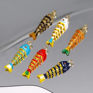 Gros plan détaillé de pendentifs carpe koi en émail coloré avec placage à l'or et reflet