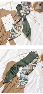 Detail of army green and orange narrow silk scarf with vintage clock and gear pattern