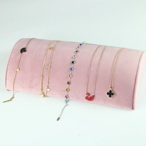 Detail of pink velvet jewelry display stand showing soft texture and semi-circular design