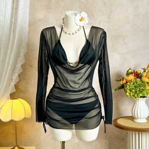 Close-up of black 3-piece bikini set with sheer mesh cover-up and gold metal buckle detail