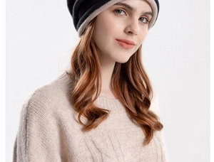 Close-up of a two-tone black and beige knit slouchy beanie with warm textured fabric