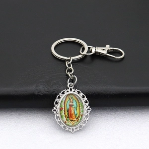 Detailed view of Our Lady of Guadalupe metal keychain with ornate hollowed edges