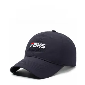 Close-up of FBXS letter embroidery and red details on navy quick-dry baseball cap