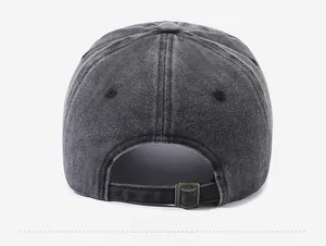 Detail of washed grey cotton baseball cap showing back view with bronze metal buckle