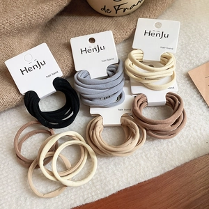 Detailed view of seamless elastic hair bands in neutral earthy tones with card display
