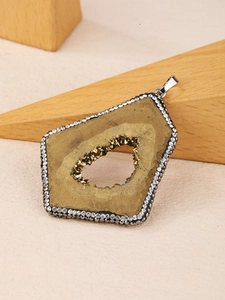 Detail of natural agate geode pendant with sparkling crystals and rhinestone edge
