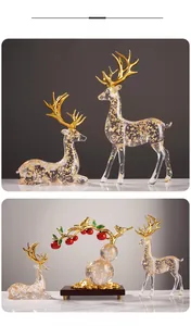 Detail of transparent resin reindeer statues with gold foil flakes and red berry gourd tree
