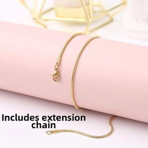 Detail shot of the golden snake bone chain with lobster clasp and adjustable extension link