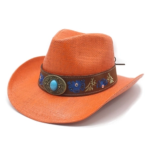 Detailed weave of orange straw cowboy hat with embroidered turquoise leather band