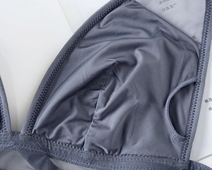 Detailed macro view of blue-grey breathable mesh fabric with premium side padding pocket