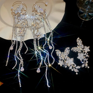 Macro shot of silver butterfly ear cuff with sparkling rhinestone tassels and luxury finish
