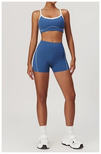 Detail of navy blue two-piece yoga set featuring white contrast stitching on sportswear