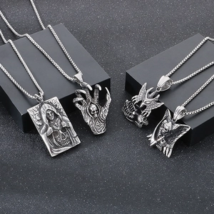 Close-up of gothic stainless steel pendants featuring grim reaper and demon skull motifs