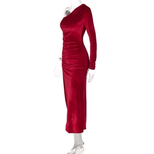 Détail de la robe en velours rouge avec épaule dénudée et plis élégants à la taille
