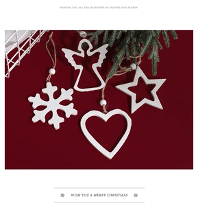 Set of four white wooden Christmas ornaments with snowflake, angel, heart, and star shapes